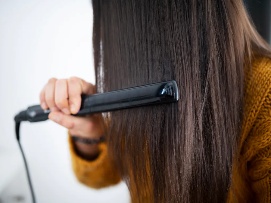 Hair being styled with a heat tool