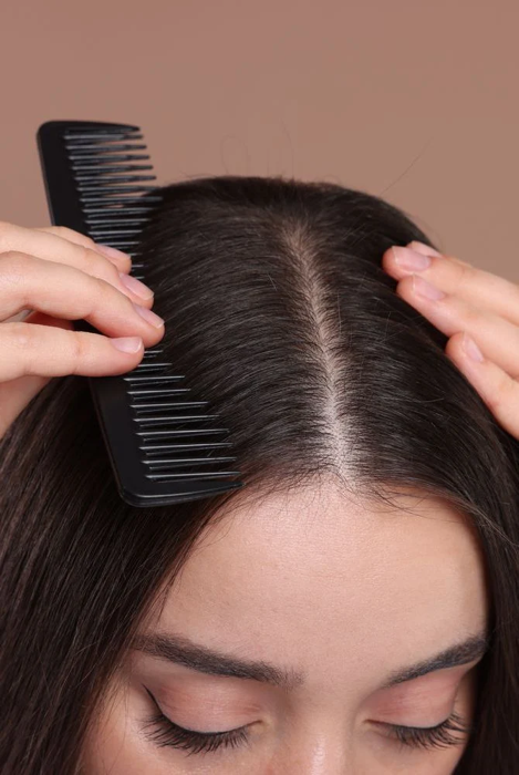 A comb parting clean, healthy hair at the scalp